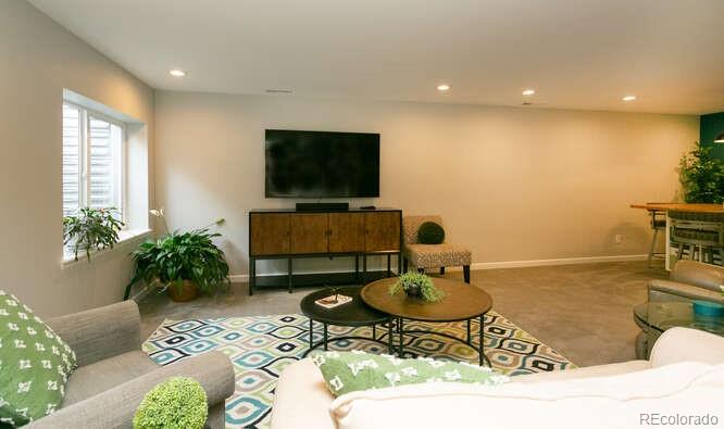 9772 Quay Loop Westminster, CO 80021 - Photo 25 of 36 a living room with furniture and a flat screen tv