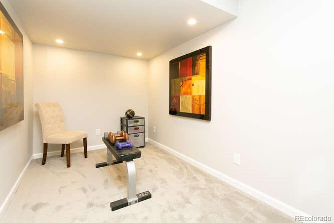 9772 Quay Loop Westminster, CO 80021 - Photo 28 of 36 a room with furniture and a wooden floor