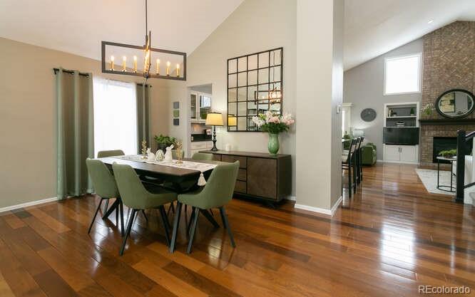 9772 Quay Loop Westminster, CO 80021 - Photo 3 of 36 a view of a dining room with furniture and wooden floor