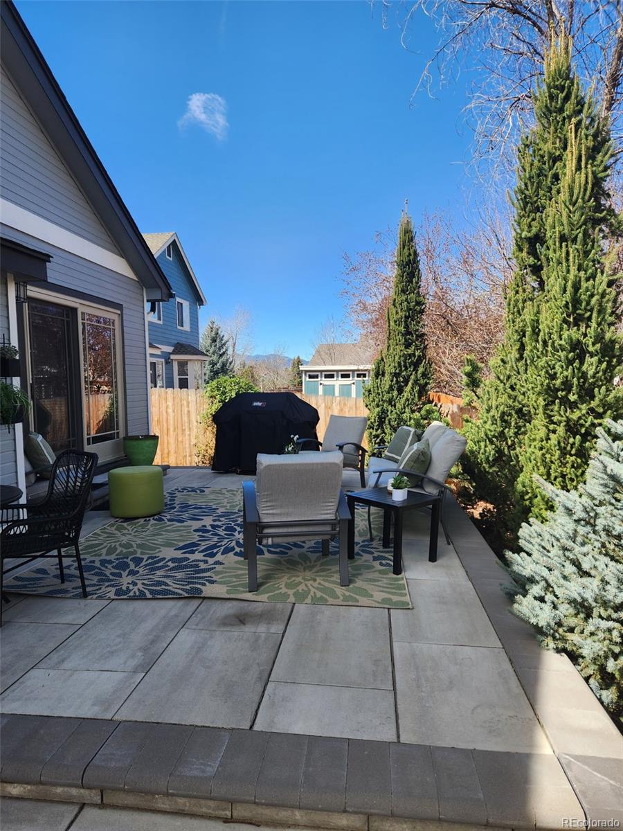 9772 Quay Loop Westminster, CO 80021 - Photo 32 of 36 a view of a patio with table and chairs and potted plants