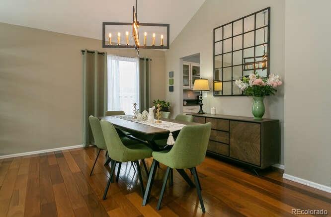 9772 Quay Loop Westminster, CO 80021 - Photo 4 of 36 a view of a dining room with furniture and wooden floor