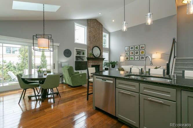 9772 Quay Loop Westminster, CO 80021 - Photo 9 of 36 a kitchen with a table chairs and a chandelier