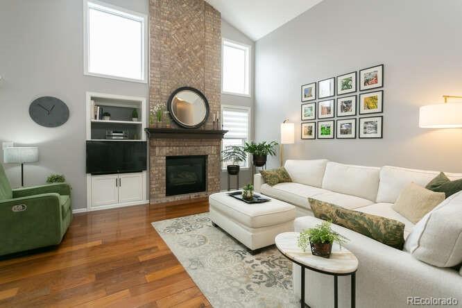 9772 Quay Loop Westminster, CO 80021 - Photo 10 of 36 a living room with furniture a rug and a fireplace