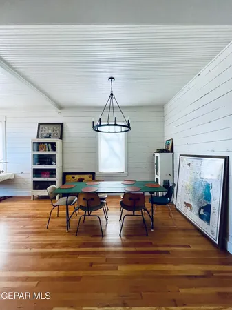 a view of a dining room with furniture wooden floor and a chandelier