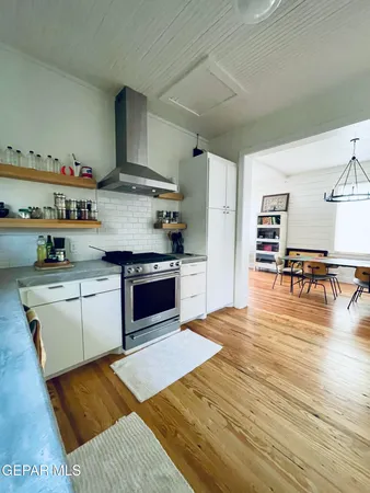 a kitchen with stainless steel appliances granite countertop a stove and a refrigerator