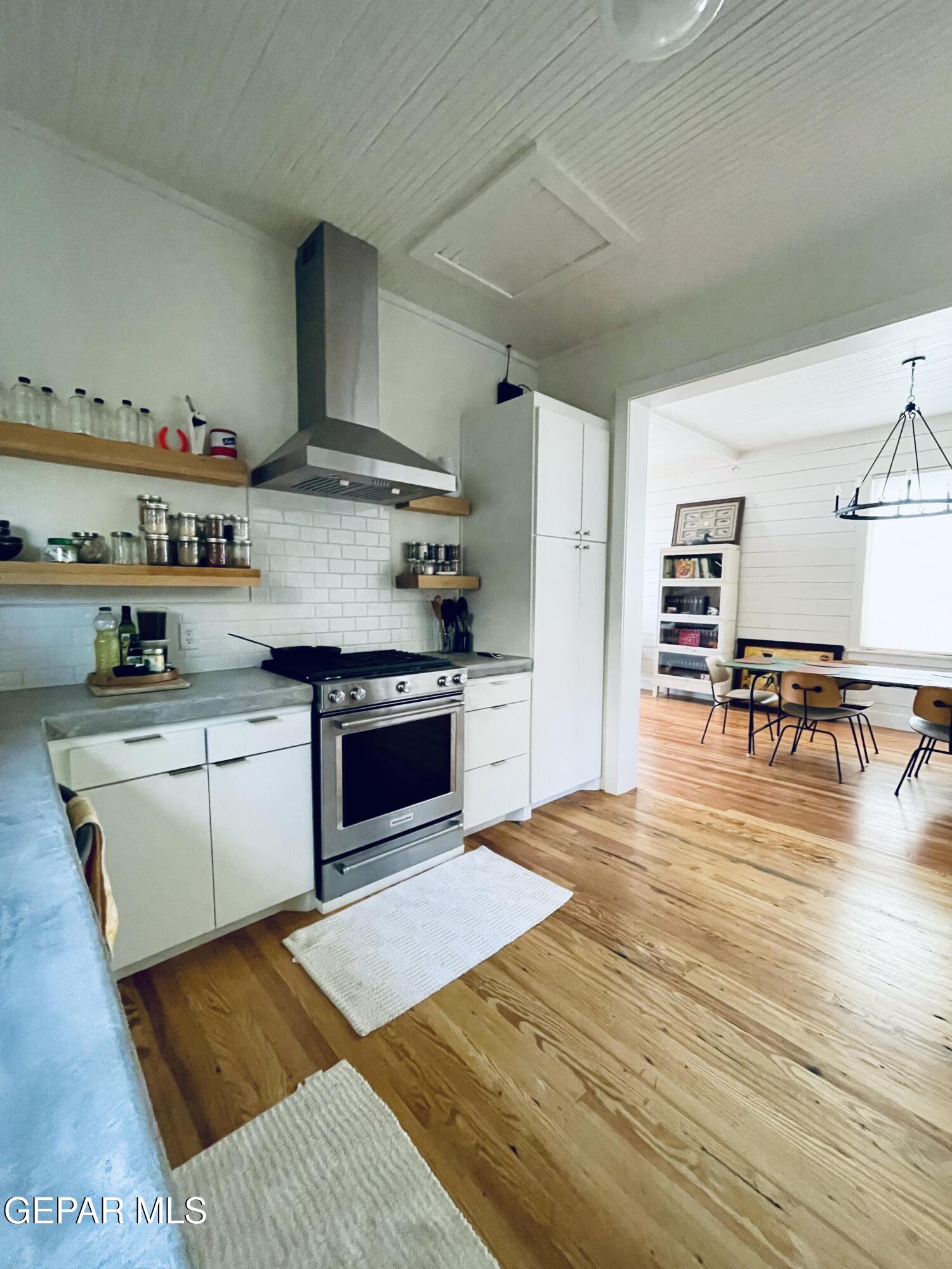 215 East Texas Street Marfa, TX 79843 - Photo 8 of 15 a kitchen with stainless steel appliances granite countertop a stove and a refrigerator