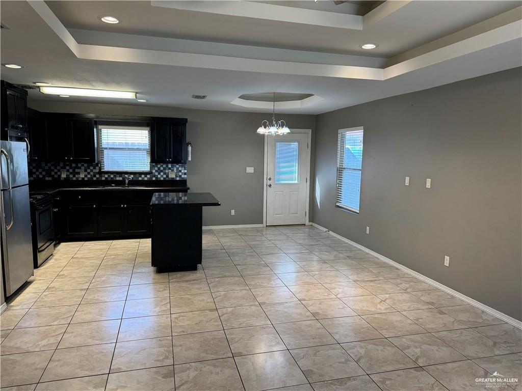 4709 North Ebony Street, Unit 3 Pharr, TX 78577 - Photo 4 of 11 a large kitchen with kitchen island granite countertop a large counter top stainless steel appliances and cabinets