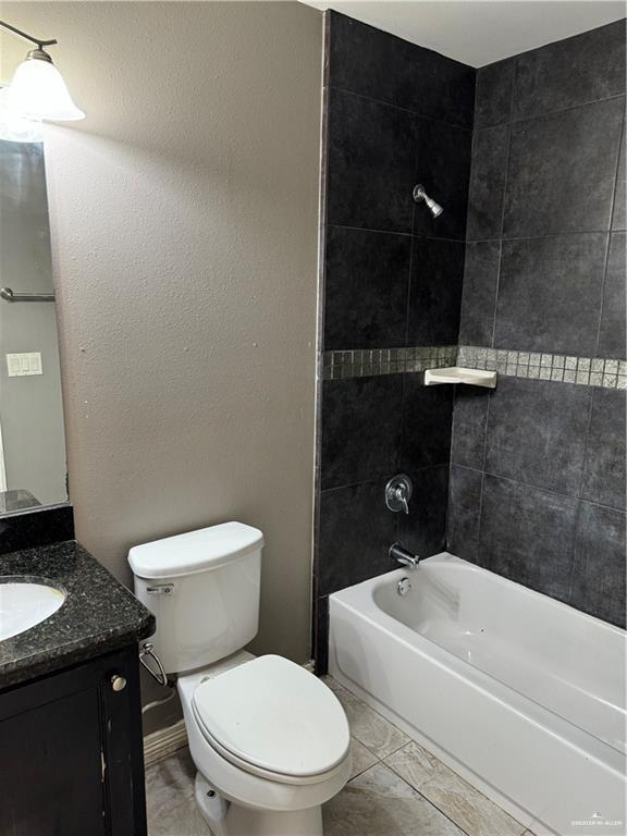 4709 North Ebony Street, Unit 3 Pharr, TX 78577 - Photo 7 of 11 a bathroom with a granite countertop toilet and a bathtub