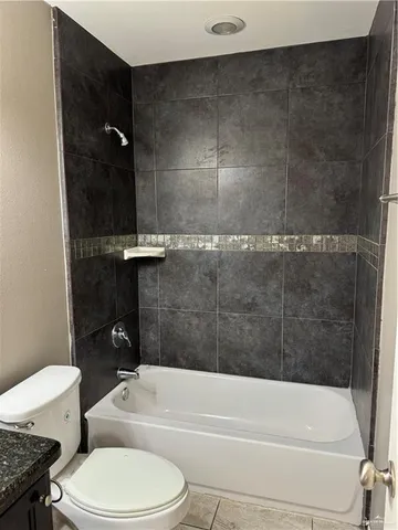 a bathroom with a toilet and a tub