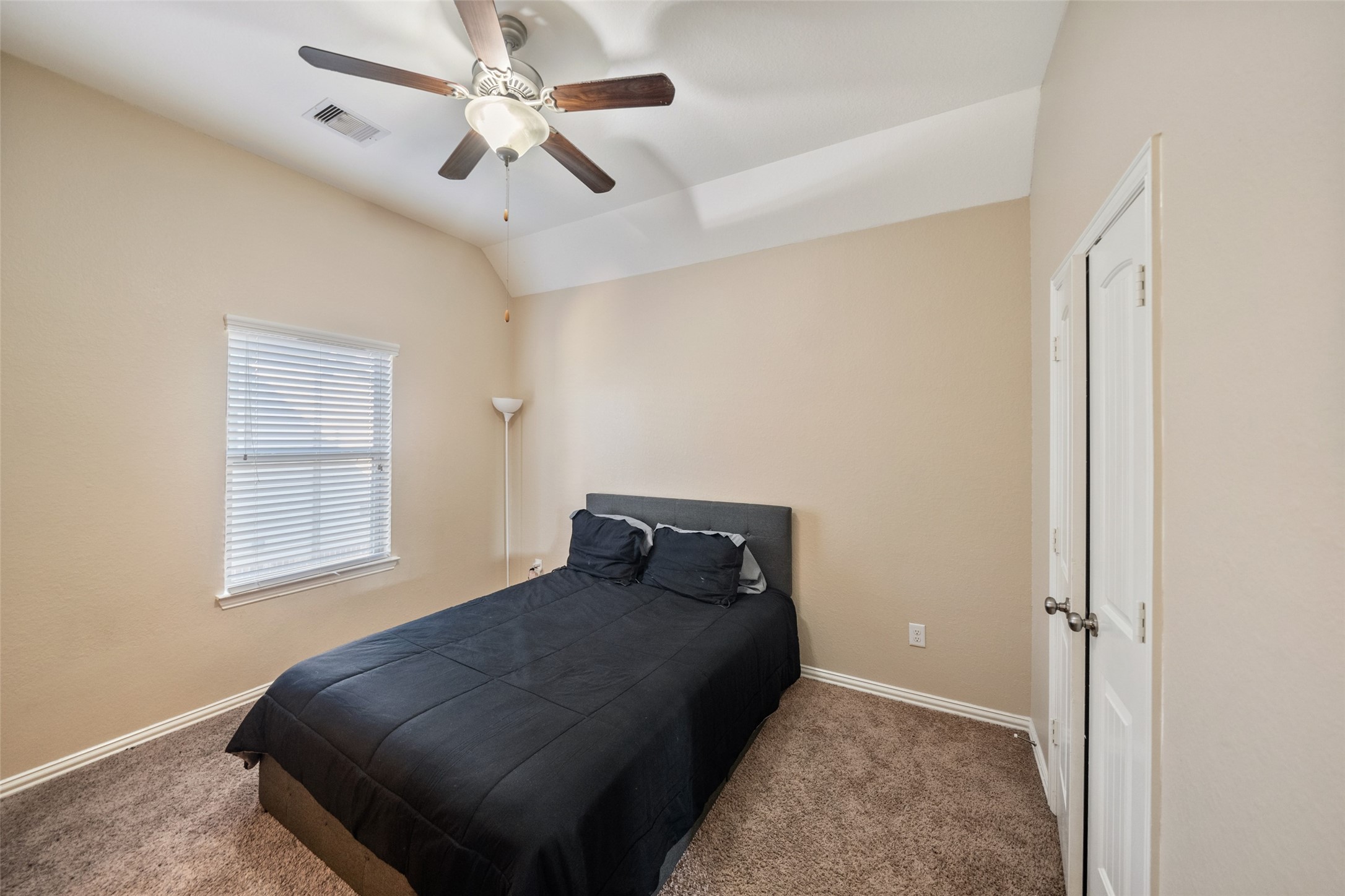 4747 Abercorn Street Rosharon, TX 77583 - Photo 6 of 46 This cozy bedroom features a neutral color palette, carpeted flooring, and a ceiling fan. It includes a window for natural light and a closet with double doors. Ideal for a comfortable retreat or guest.