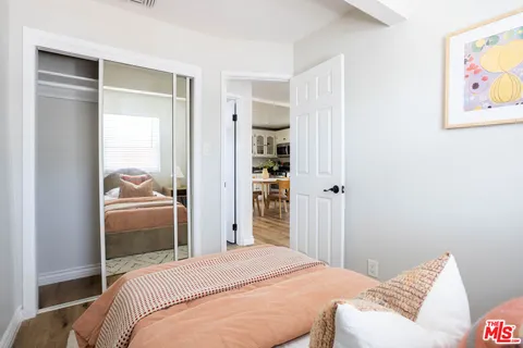 a bedroom with a bed and a painting on the wall