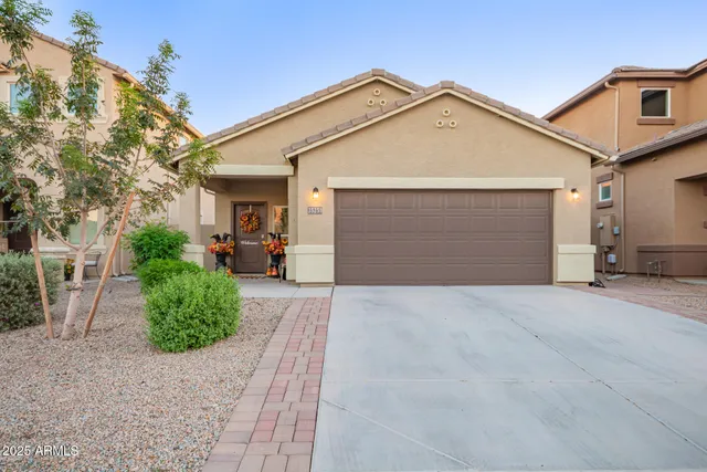 a front view of a house with a yard and garage
