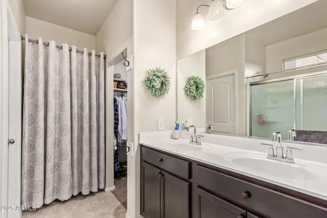 a bathroom with a double vanity sink and a mirror