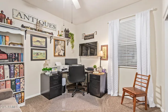 a view of a workspace with furniture and a window