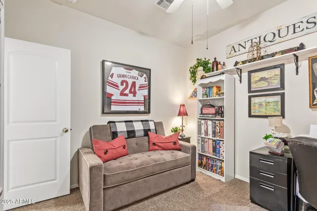 a living room with furniture and a baby crib