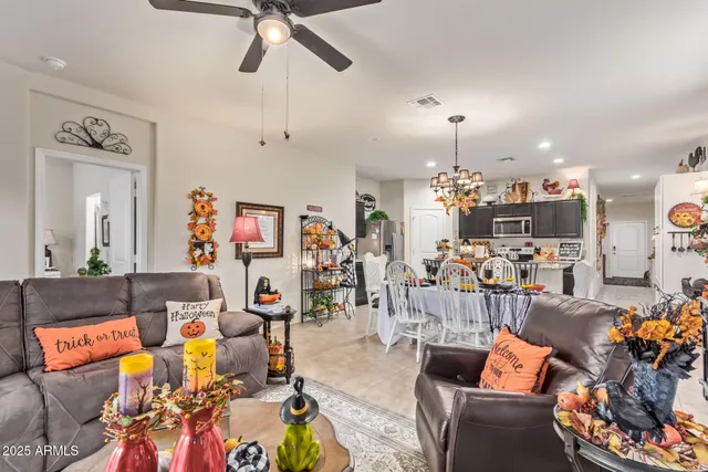 a living room with lots of furniture and a view of kitchen