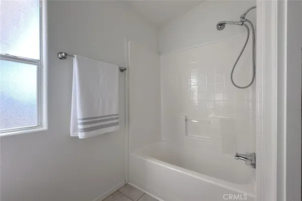 a bathroom with a bath tub with a shower
