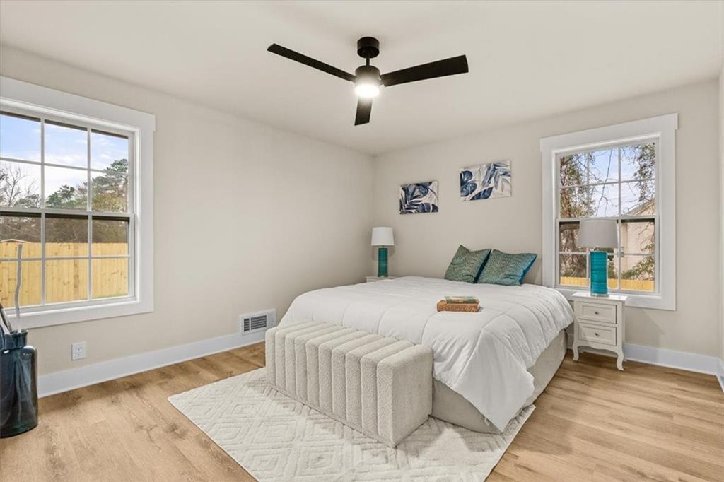 4203 Annistown Road Snellville, GA 30039 - Photo 16 of 32 a bedroom with a large bed and a large window