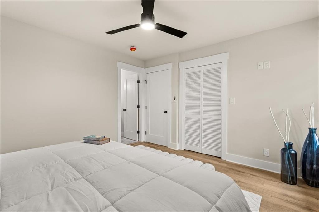 4203 Annistown Road Snellville, GA 30039 - Photo 17 of 32 a bedroom with a large bed and a chandelier