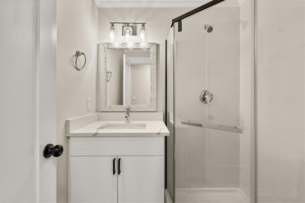 4203 Annistown Road Snellville, GA 30039 - Photo 18 of 32 a bathroom with a shower sink and mirror