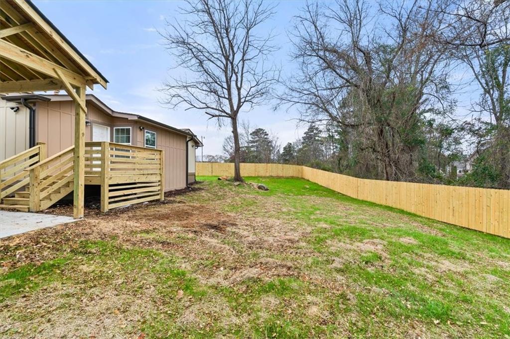 4203 Annistown Road Snellville, GA 30039 - Photo 28 of 32 a view of a backyard with large trees