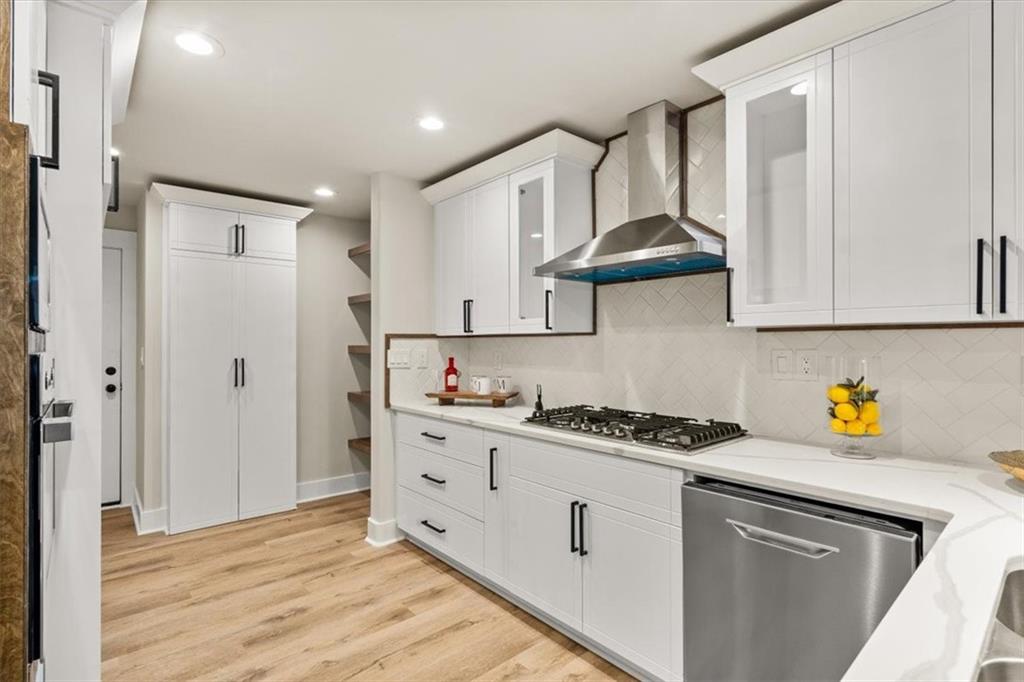 4203 Annistown Road Snellville, GA 30039 - Photo 4 of 32 a kitchen with stainless steel appliances granite countertop a sink stove and cabinets