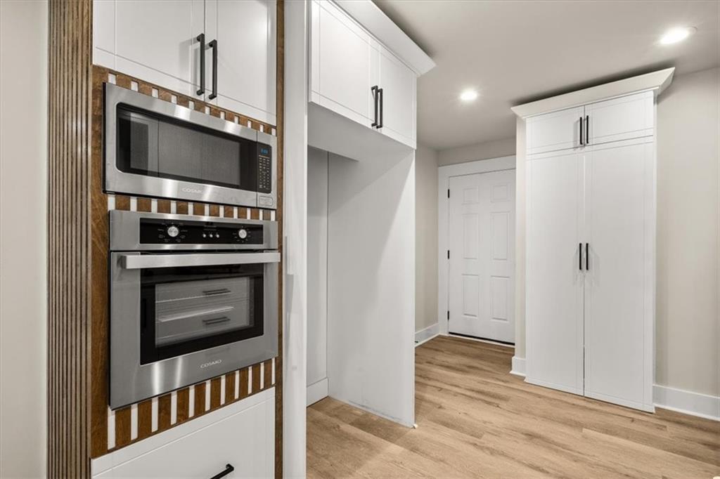 4203 Annistown Road Snellville, GA 30039 - Photo 7 of 32 a kitchen with stainless steel appliances a stove a microwave and a refrigerator