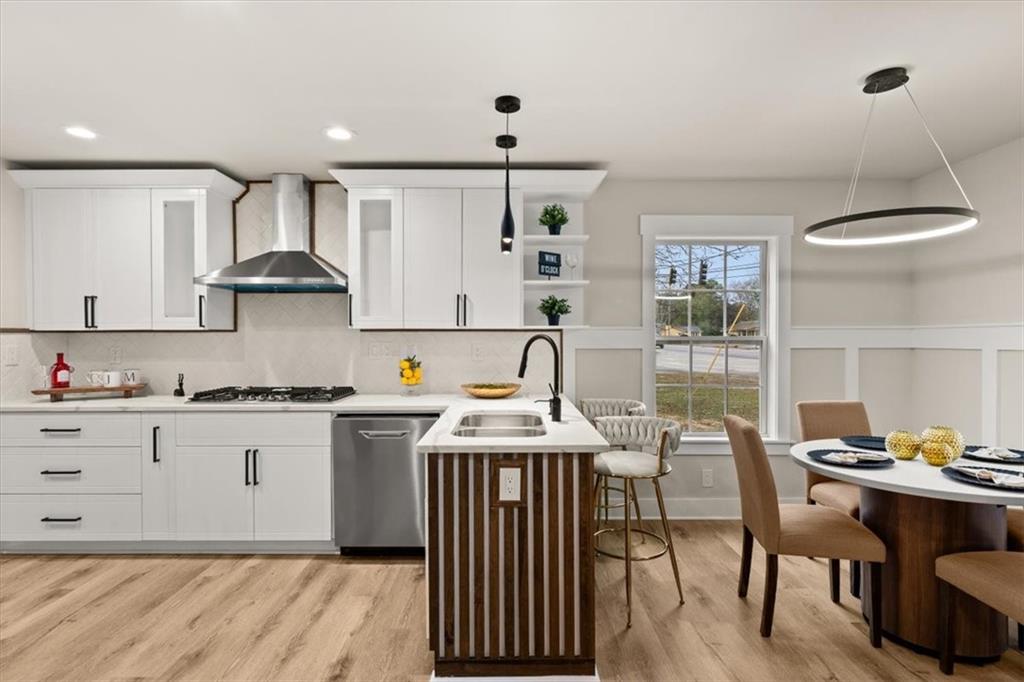 4203 Annistown Road Snellville, GA 30039 - Photo 10 of 32 a kitchen with stainless steel appliances granite countertop a stove and white cabinets