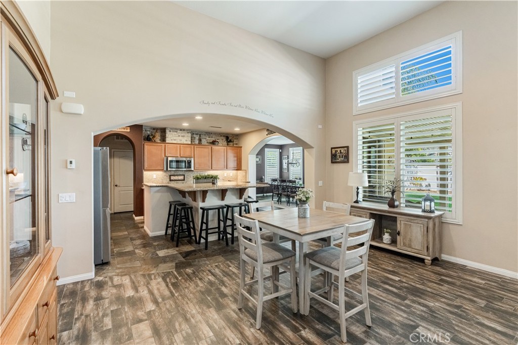 32016 Woodside Court Temecula, CA 92592 - Photo 11 of 40 a view of a dining room with furniture window and wooden floor