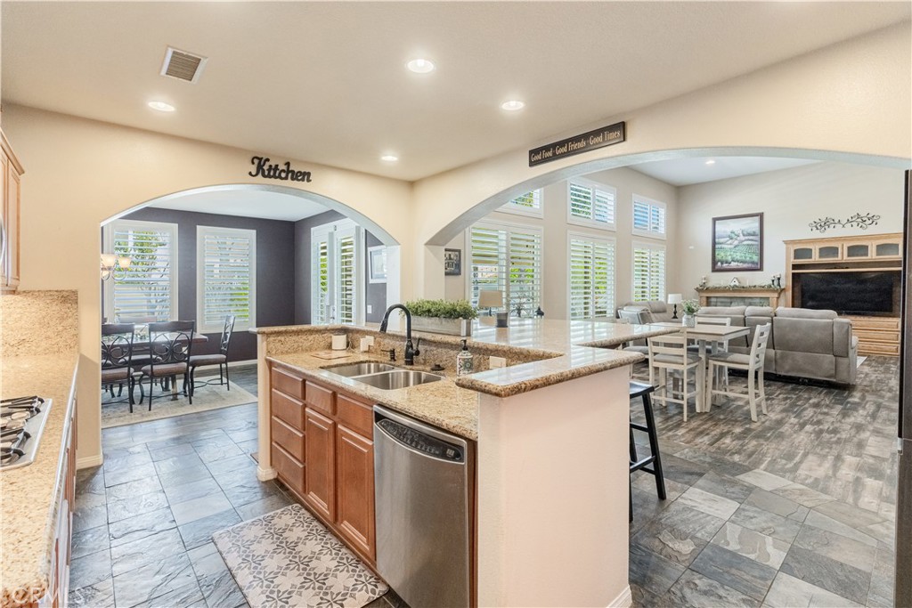 32016 Woodside Court Temecula, CA 92592 - Photo 13 of 40 a large kitchen with kitchen island a sink and a stove in it