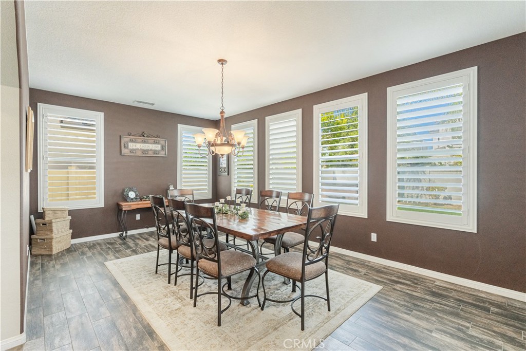 32016 Woodside Court Temecula, CA 92592 - Photo 14 of 40 a view of a dining room with furniture window and wooden floor
