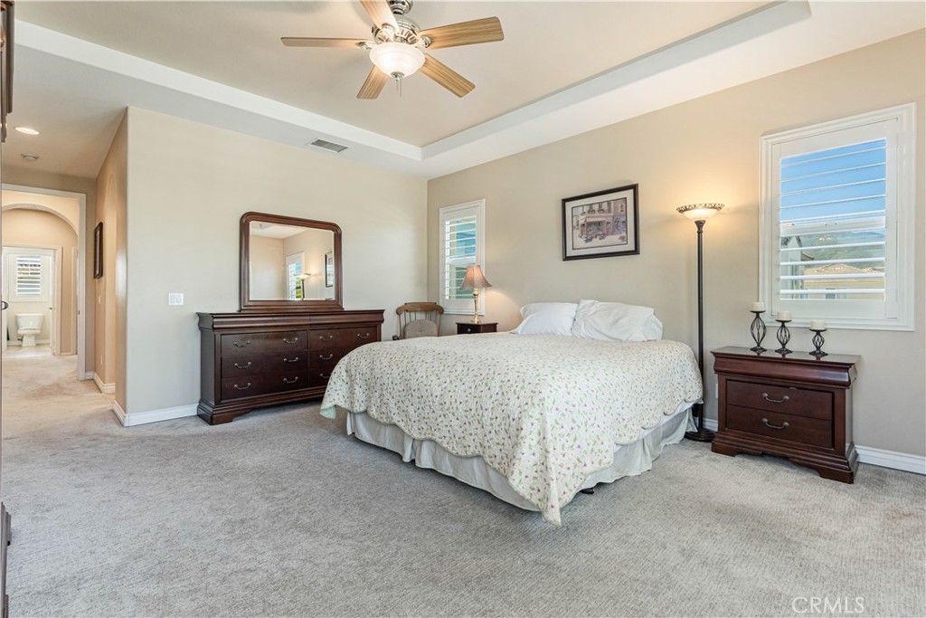 32016 Woodside Court Temecula, CA 92592 - Photo 18 of 40 a bedroom with a bed and a chandelier