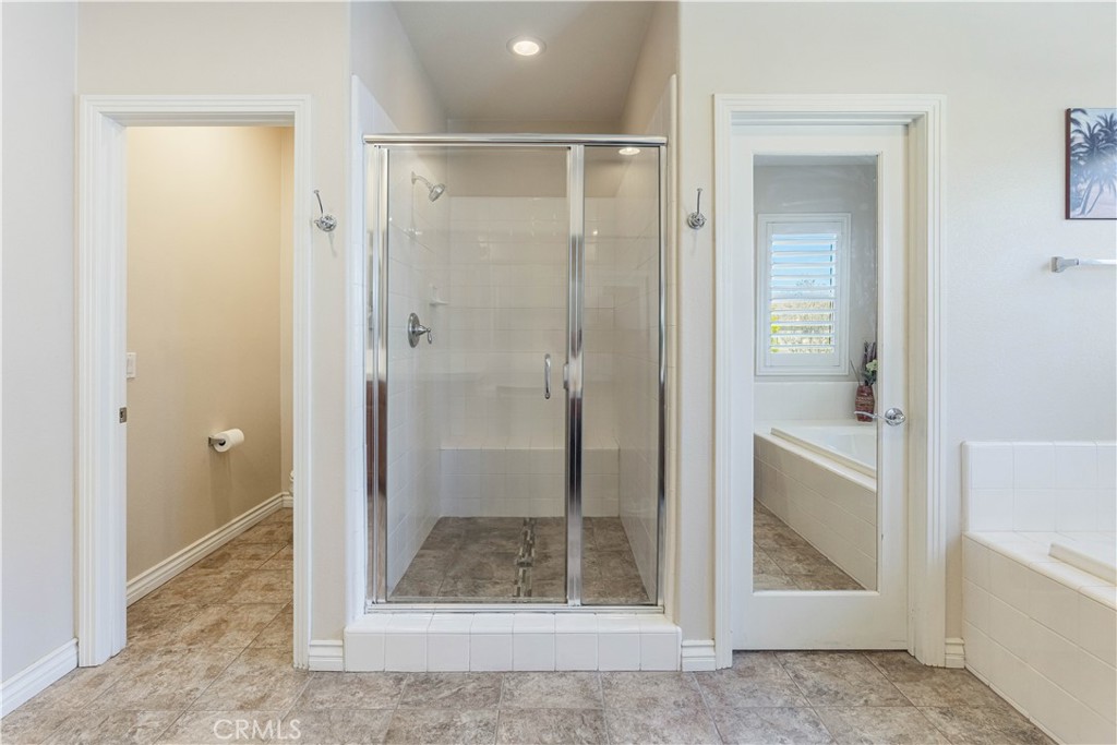 32016 Woodside Court Temecula, CA 92592 - Photo 20 of 40 a bathroom with a shower and toilet