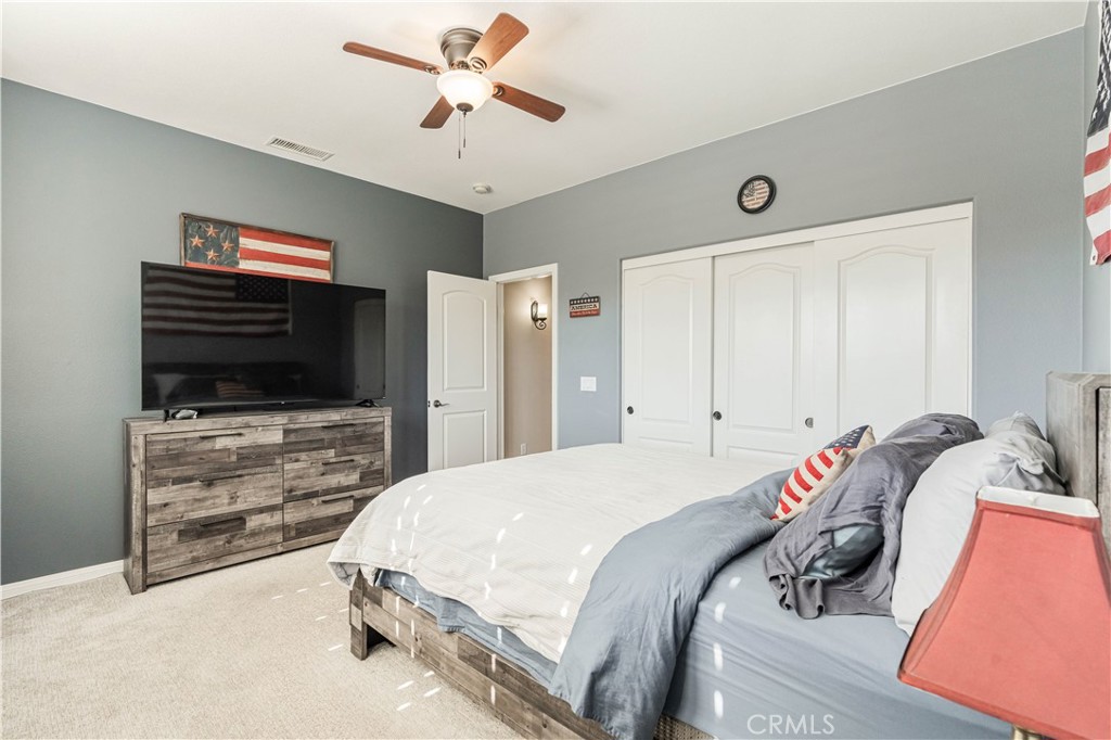 32016 Woodside Court Temecula, CA 92592 - Photo 24 of 40 a bedroom with a bed and a flat screen tv