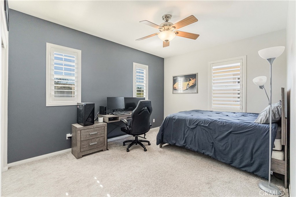 32016 Woodside Court Temecula, CA 92592 - Photo 25 of 40 a bedroom with a bed a desk chair and a window