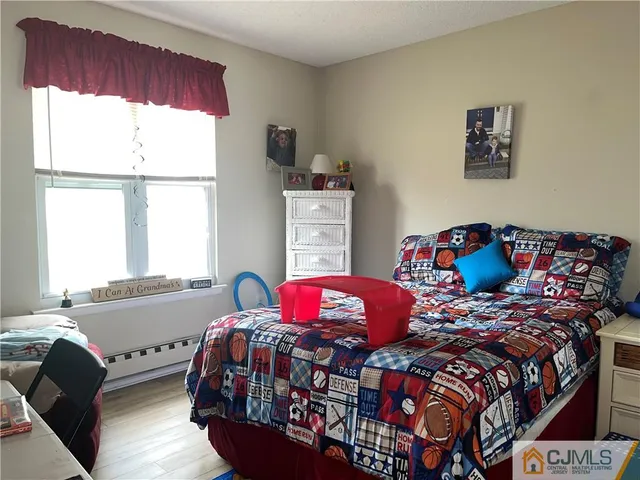 a bedroom with two beds and a large window