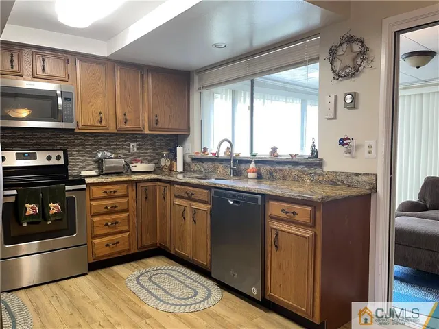 a kitchen with a stove a sink and a microwave