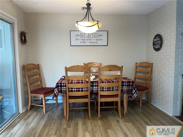 a view of a room with furniture and wooden floor