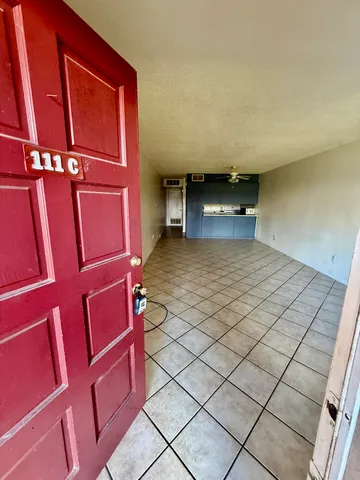 a view of a room with an empty space and a window