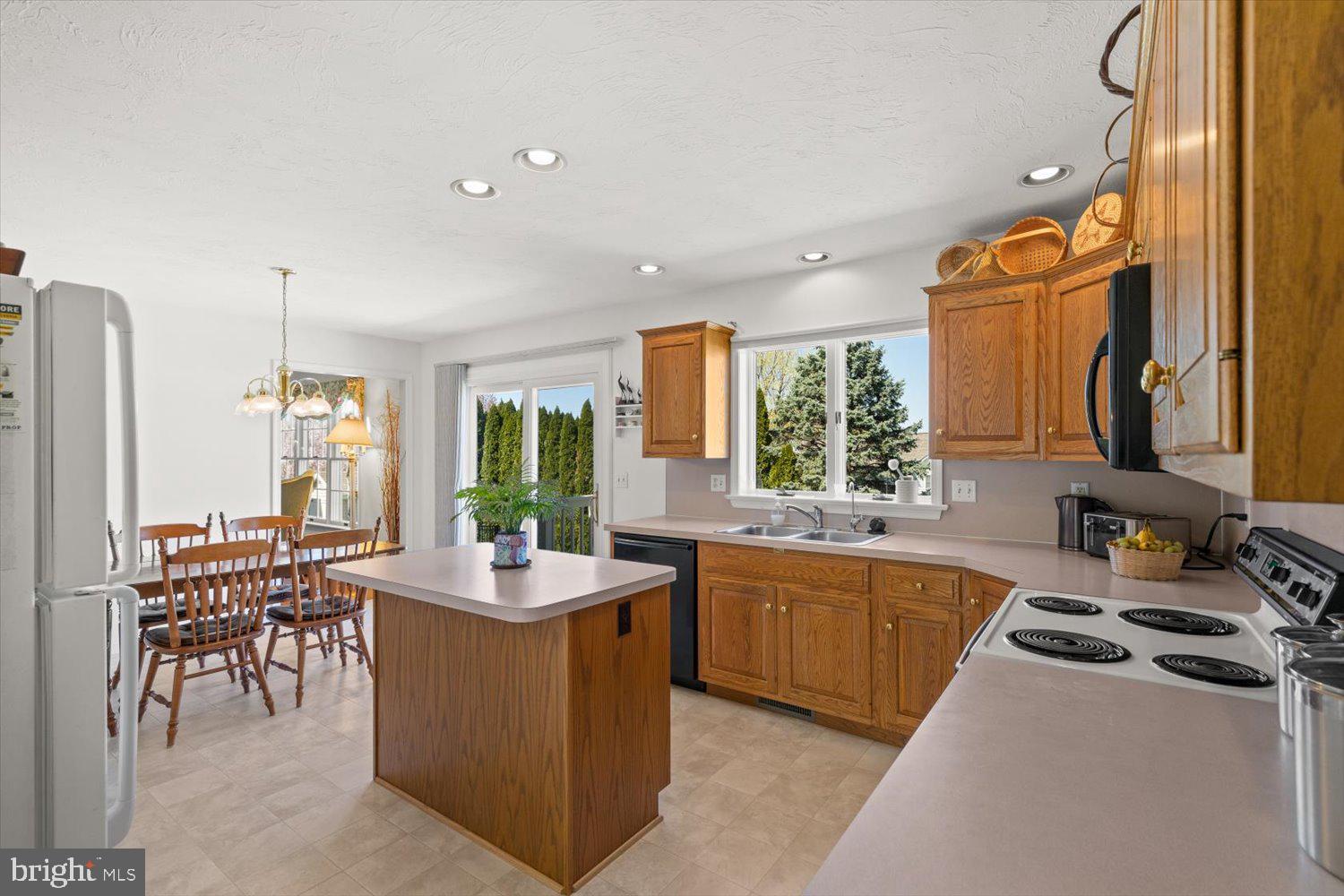 34 Ream Road Stevens, PA 17578 - Photo 11 of 53 a room with kitchen island granite countertop a sink stove and cabinets