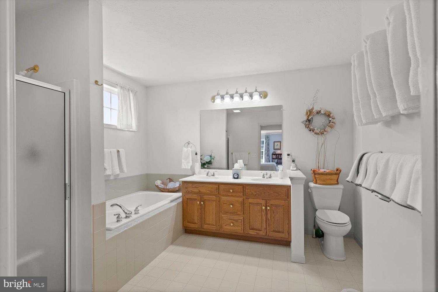 34 Ream Road Stevens, PA 17578 - Photo 23 of 53 a bathroom with a granite countertop toilet a sink and a bathtub