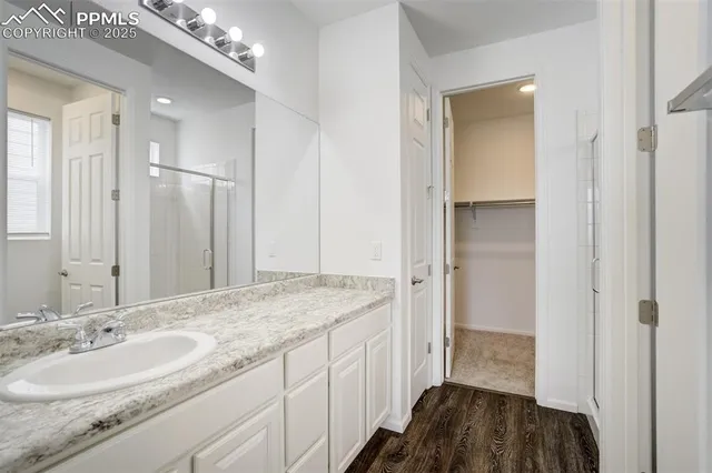 a spacious bathroom with a sink a mirror and a shower