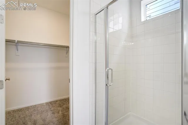 a bathroom with a glass shower door