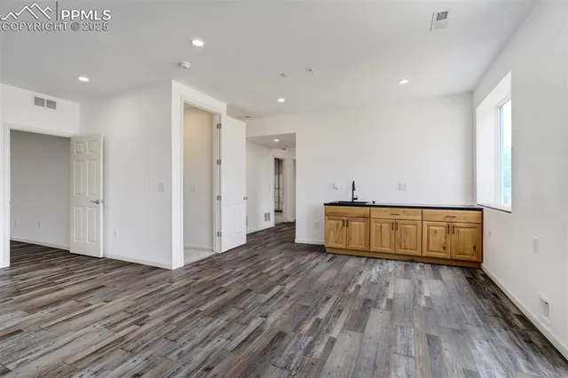 a view of a room with wooden floor