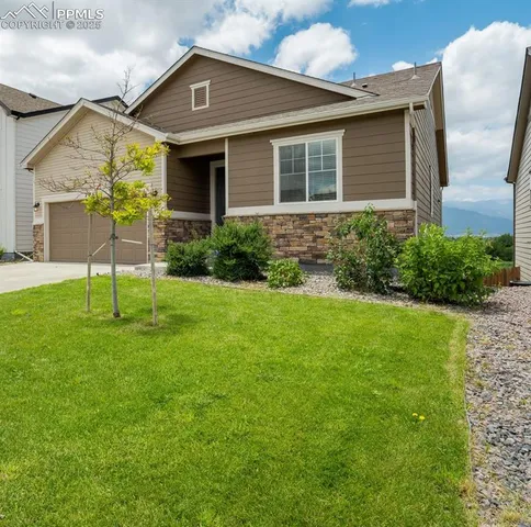 a front view of a house with a yard