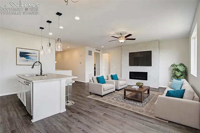 a living room with furniture a fireplace and a flat screen tv