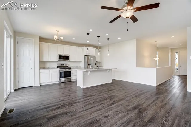 a view of kitchen with cabinets and wooden floor