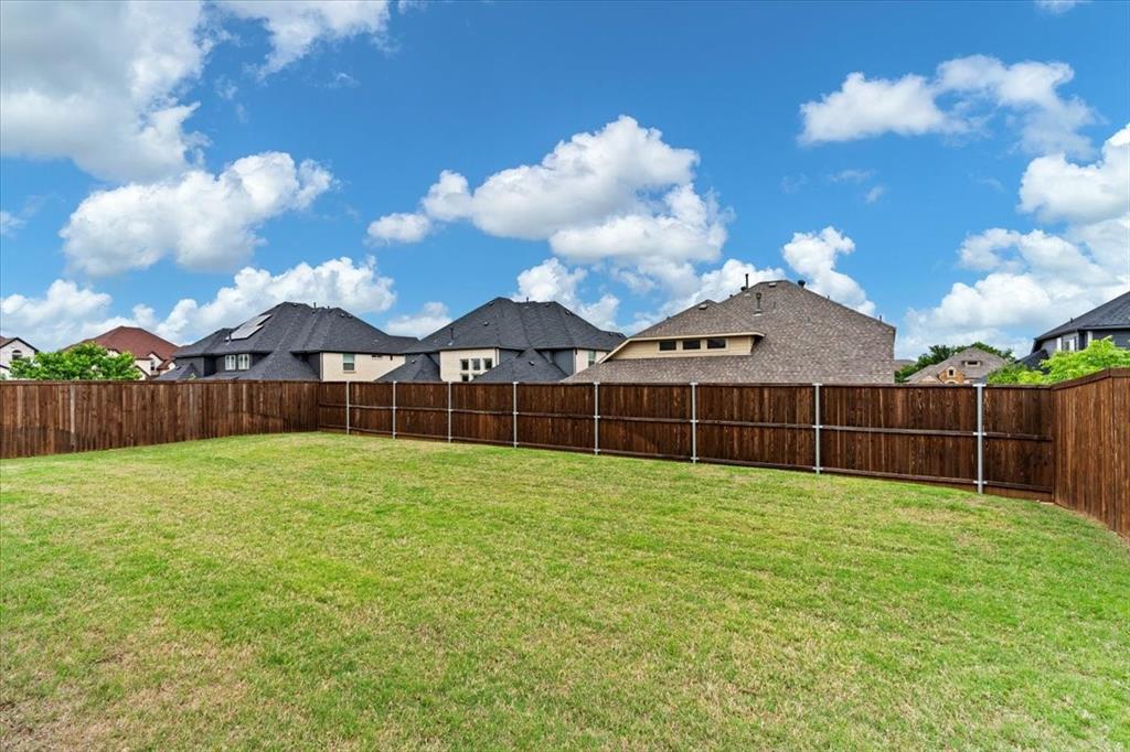 620 Shadow Trail Frisco, TX 75033 - Photo 28 of 36 Expansive backyard featuring a lush green lawn and a new wood privacy fence