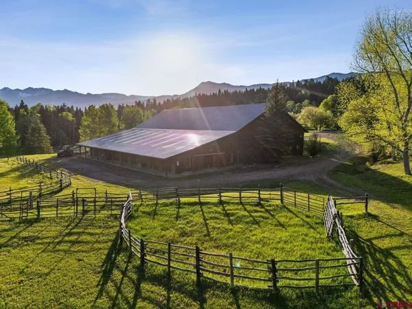 a view of backyard with swimming pool and outdoor seating