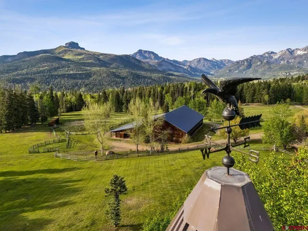 a view of a chairs and table in the balcony